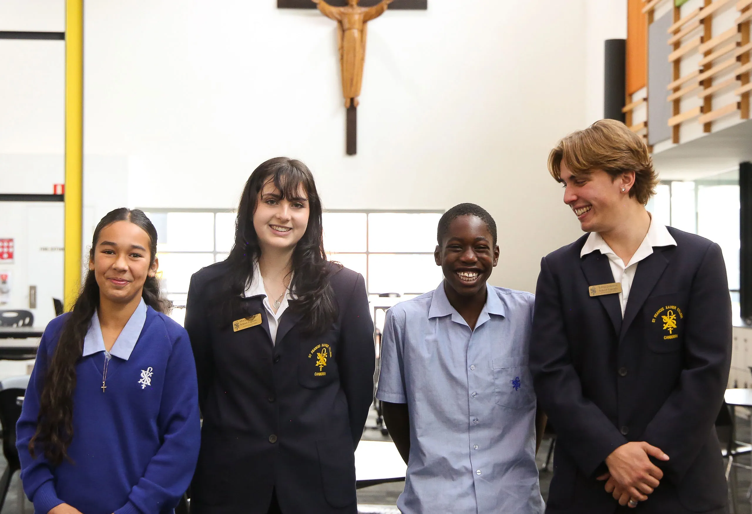 Four students standing together smiling